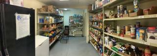 Food pantry shelves stocked with canned goods